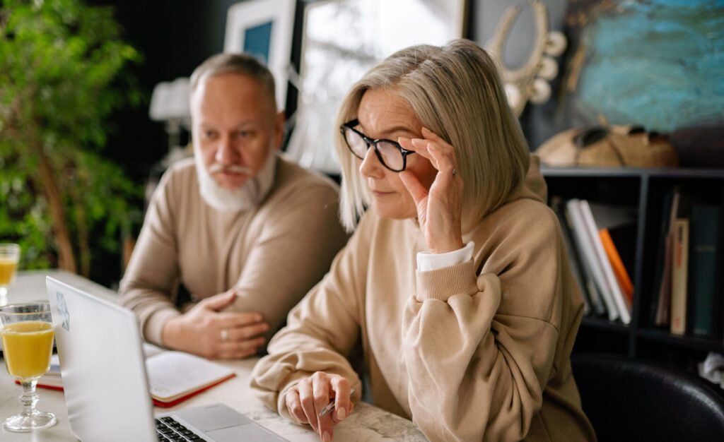 Elderly couple looking at laptop