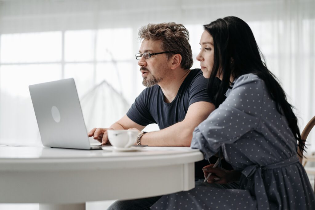 couple uses a laptop