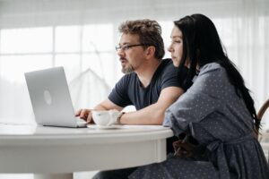 couple uses a laptop