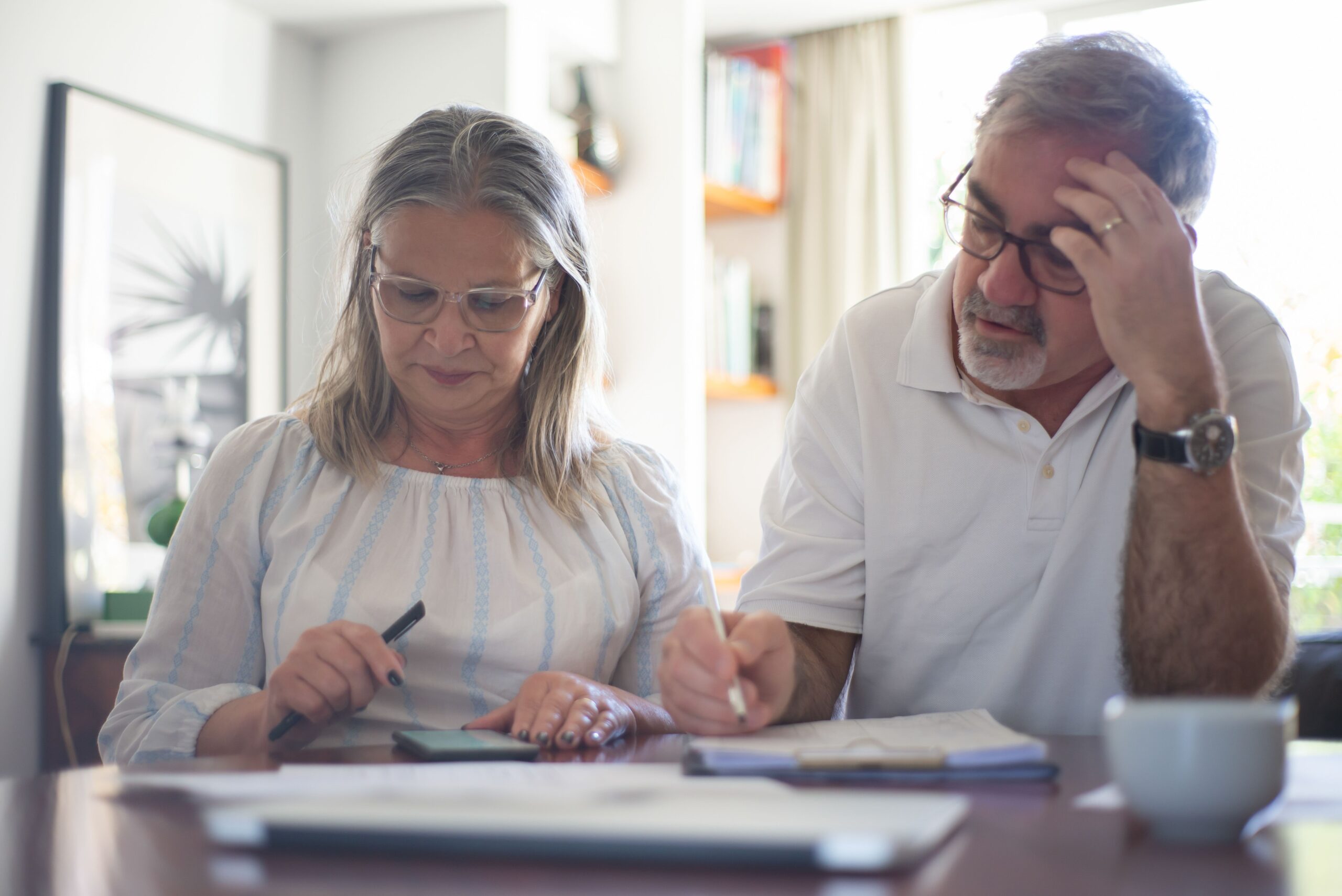 Senior couple calculating expenses
