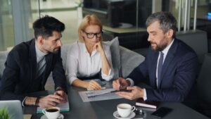 Three professionals engaged in a business discussion