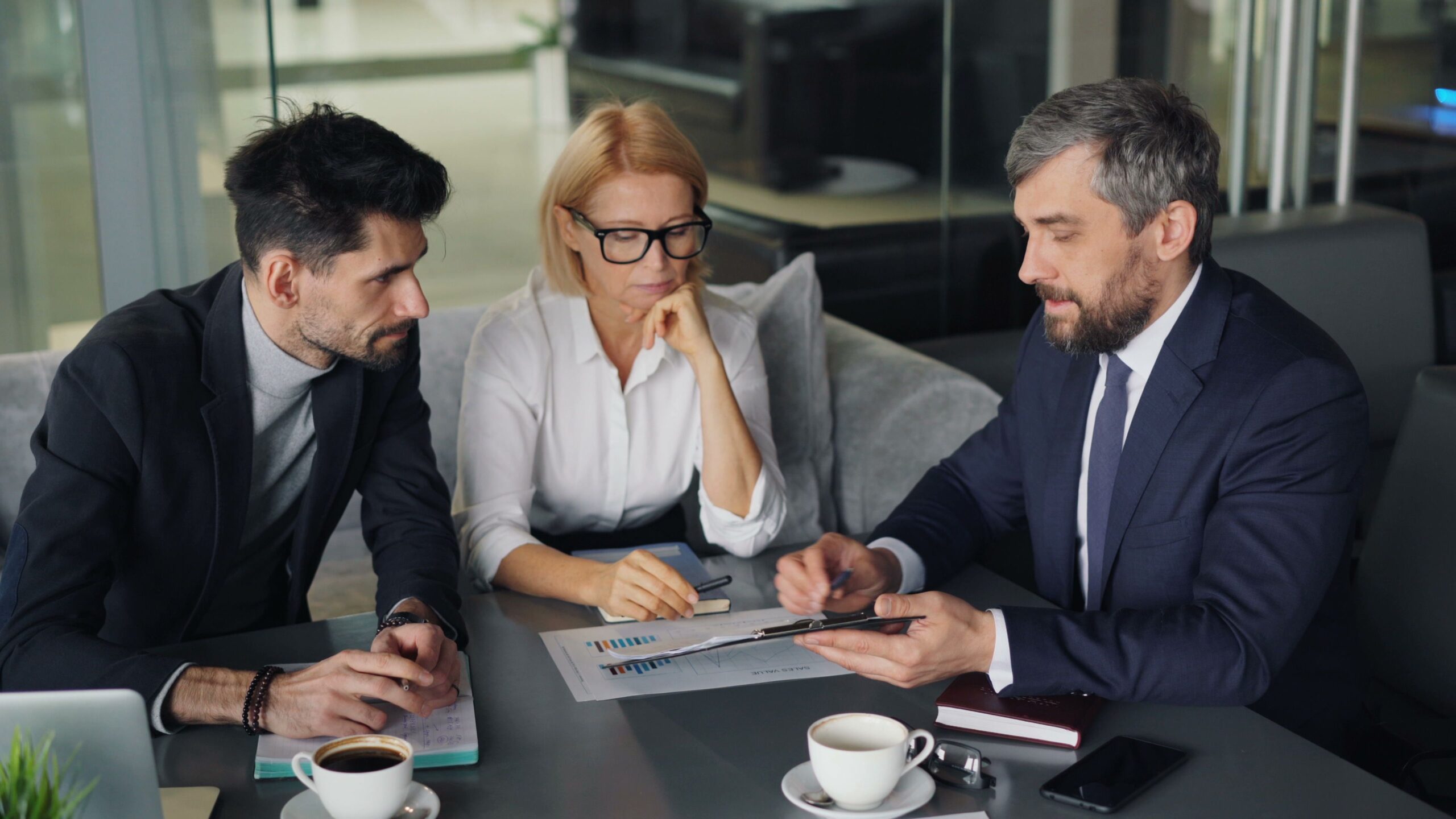 Three professionals engaged in a business discussion